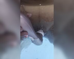 Jasmine masturbates the clitoris with a waterproof sex toy in the jaccuzy