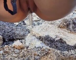 Teen peeing outside on a mountain